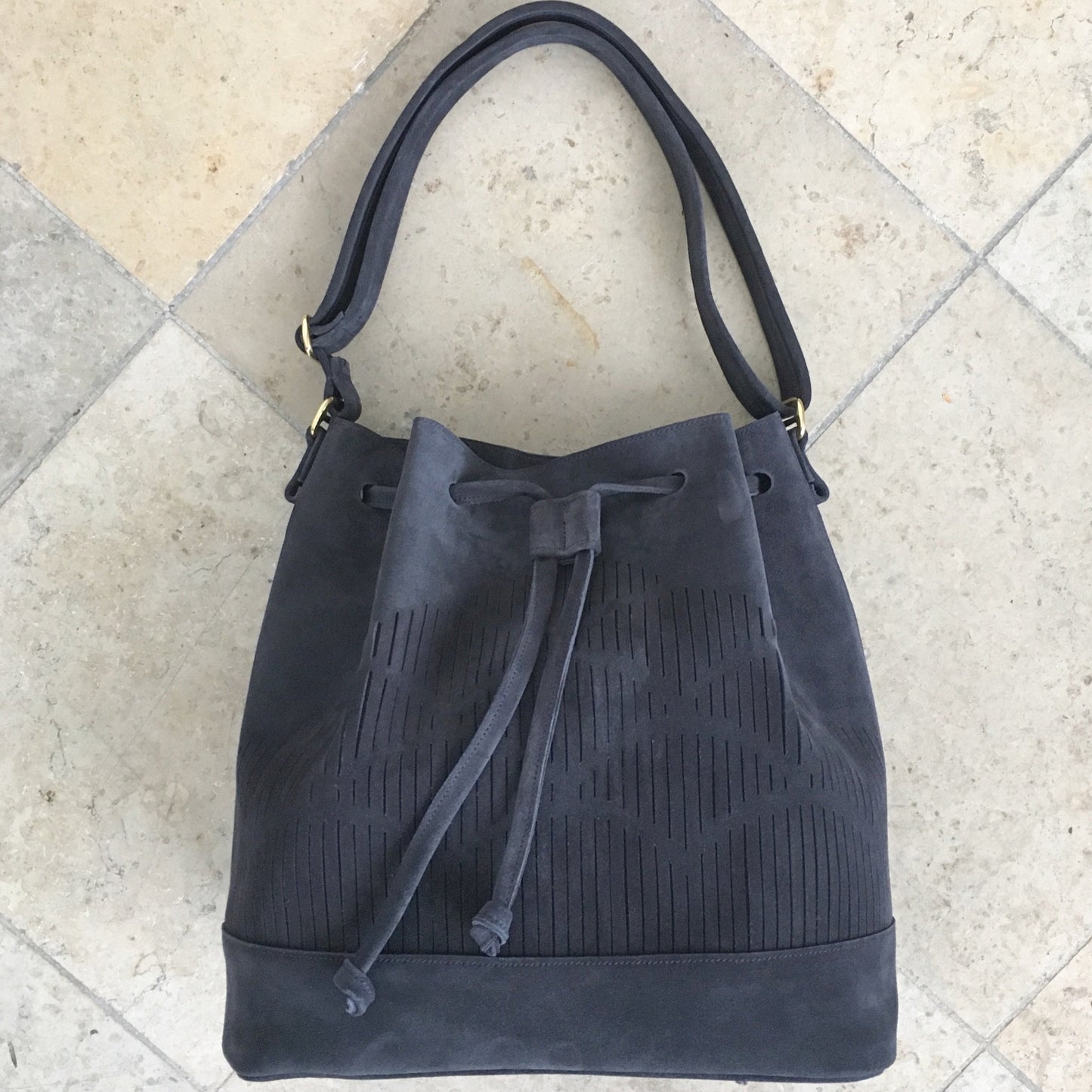 bucket bag with cut out detail blue suede leather